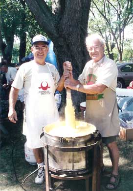 Ezio Pedri and Osvaldo Zanoni prepare polenta at the annual summer picnic